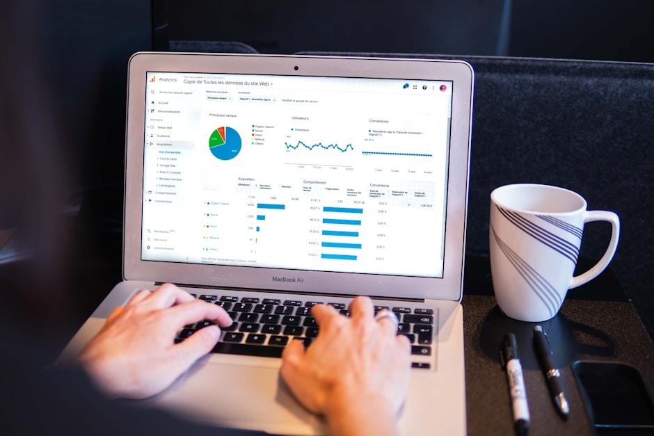 Professional working on a laptop with focused data analysis